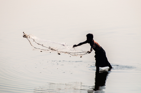 traditional fishing with handmade net, taungthaman lake, Myanmarのeditorial素材