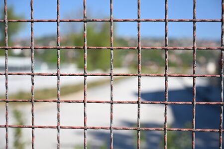 Metal fence with a square pattern for site protectionの写真素材