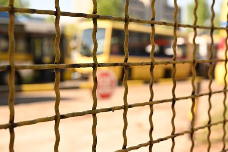 Bus depot through a metal fence