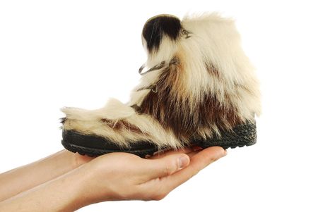 winter boots on hands on a white backgroundの写真素材