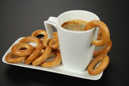 cup of black coffee and poppy bagels の写真素材