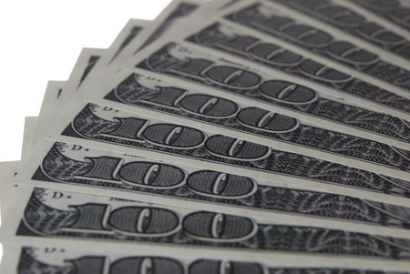 Hundred dollar bill folded like a fan on a white background