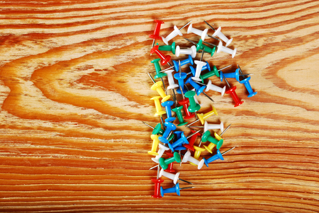 The colored pins on a wooden backgroundの写真素材