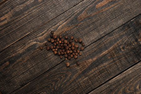 pepper, pours out of the jar on the dark wooden tableの写真素材