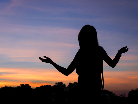 portrait of girl as silhouette with twilight backgroundの写真素材