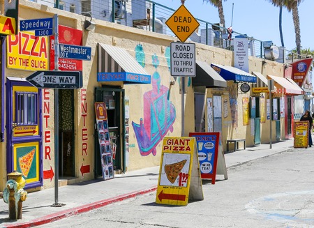 Several colorful snack shacks in a row in Venice Beach, USA.のeditorial素材