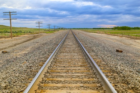 Railroad tracks and transmission lines next them near Las Animas in Colorado, USA.の写真素材