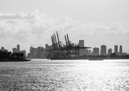 The entrance to the Port of Miami with a tugboat and the skyline in the back.のeditorial素材