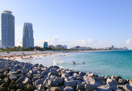 People sunbathing and swimming in Miami Beach in the evening.のeditorial素材