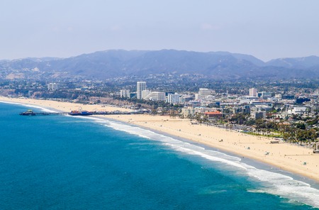 Los Angeles, USA - May 27, 2015: Aerial view of Santa Monica State Beach, in the back residential buildings, Santa Monica Pier and the mountains.のeditorial素材