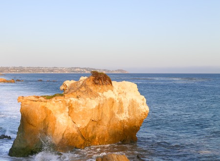 Sunlit rock hit by waves at El Matador State Beach in Malibu, USA.の写真素材