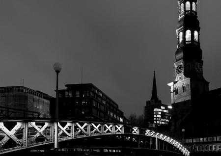Hamburg, Germany - March 9, 2017 - View of the Jungfern Bridge and the Saint Catherines Church in the Old Town at night in black and white.のeditorial素材