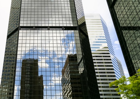 Denver, USA - May 25, 2016: Looking up skyscrapers of the World Trade Center Denver with opposing buildings and the sky reflecting in the facade.のeditorial素材