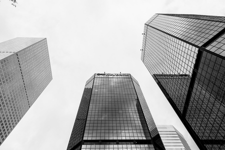 Denver, USA - May 25, 2016: Looking up skyscrapers of the World Trade Center Denver, one of them with a Keybank sign. The picture is in monochrome.のeditorial素材