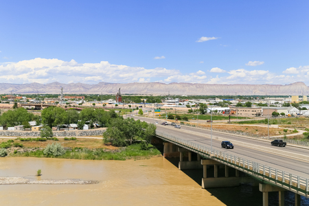 Grand Junction, USA - May 28, 2016: Highway bridge over the confluence of the Gunnison River and Colorado River with part of the city and the Book Cliffs in the back.のeditorial素材