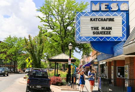 Grand Junction, USA - May 28, 2016: People walking on the boardwalk of the main street of the city with shopping and entertainment. Cars are parked on the roadside.のeditorial素材