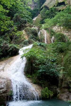 Water fall in spring season located in deep rain forest jungle,Thailandの写真素材