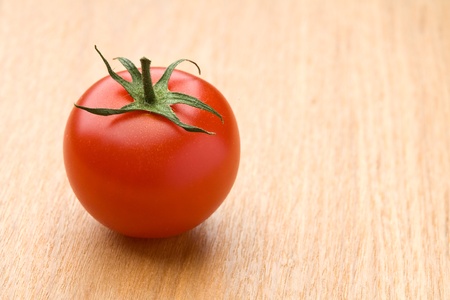 Ripe red tomato on the woodの写真素材