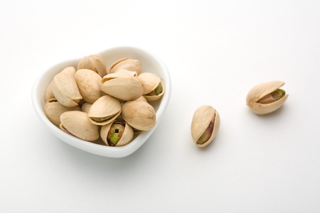 A plate and pistachio of white heartの写真素材
