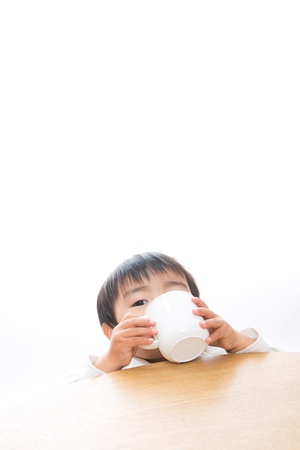 The child who drinks with a mugの写真素材