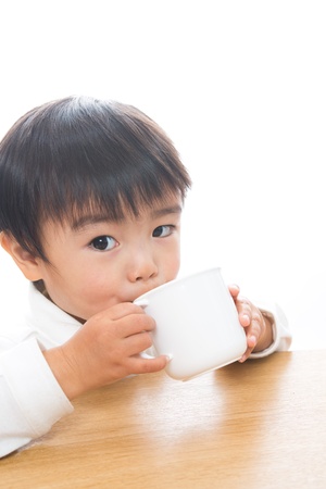 The child who drinks with a mugの写真素材