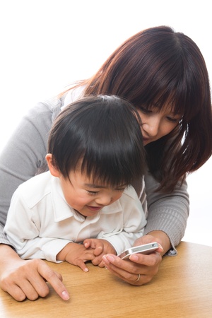 Parent and child who play with a smart phoneの写真素材