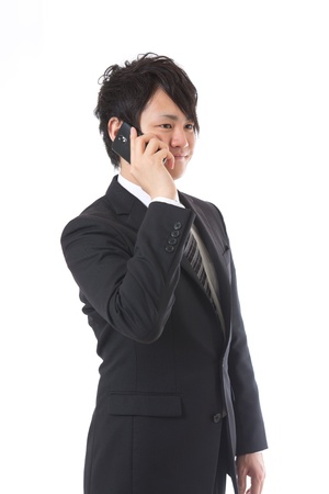The young businessman who talks on the telephoneの写真素材