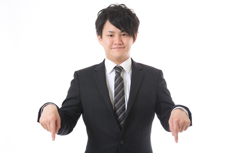 The young businessman who points to a bottomの写真素材