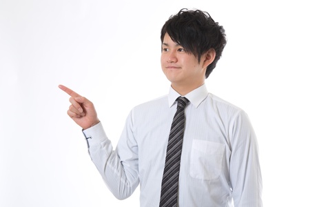 The young businessman who points to the leftの写真素材