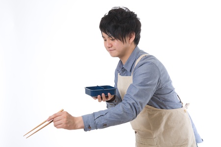 The young man who cooks a lunchの写真素材