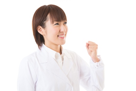 Young woman in a white coatの写真素材