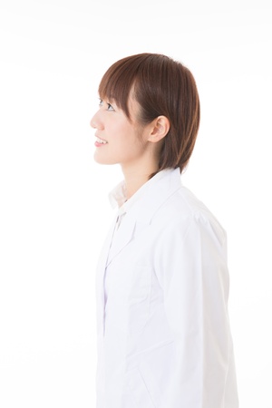 Young woman in a white coatの写真素材
