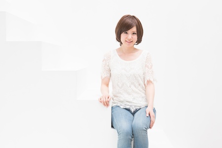 The woman who sits on the white stairsの写真素材