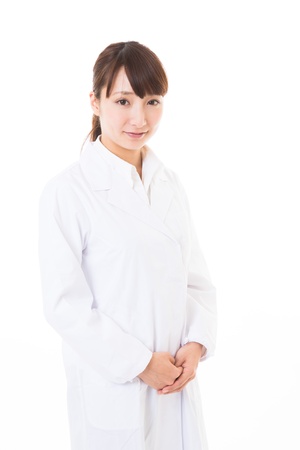 Young woman in a white coatの写真素材