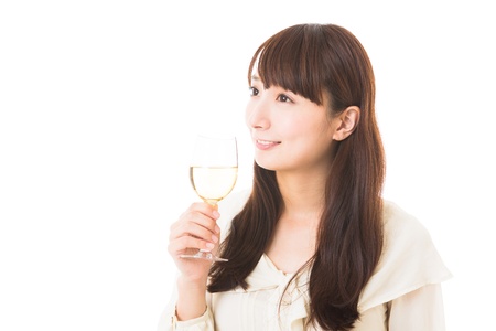 young attractive asian woman who drinks wineの写真素材