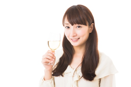 young attractive asian woman who drinks wineの写真素材