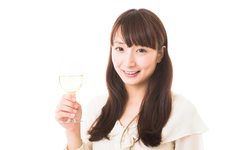 young attractive asian woman who drinks wineの写真素材