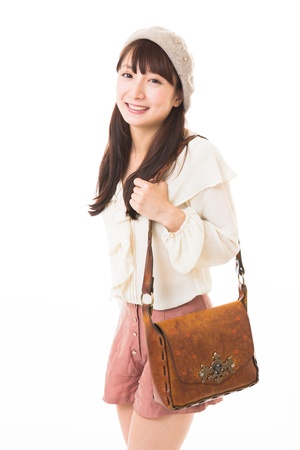 young attractive asian woman who puts on a capの写真素材