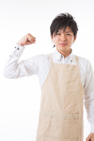 The youth who cooks with an apron figureの写真素材