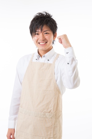 The youth who cooks with an apron figureの写真素材