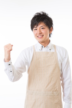 The youth who cooks with an apron figureの写真素材