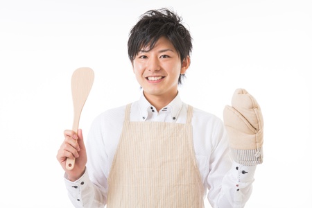 The youth who cooks with an apron figureの写真素材