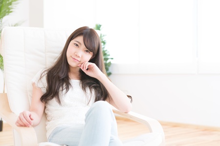 The young woman relaxing in the roomの写真素材