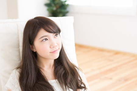 The young woman relaxing in the roomの写真素材