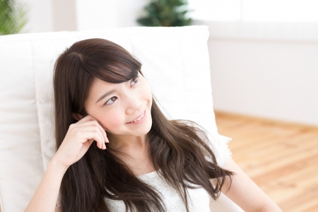 The young woman relaxing in the roomの写真素材