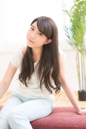 The young woman relaxing in the roomの写真素材