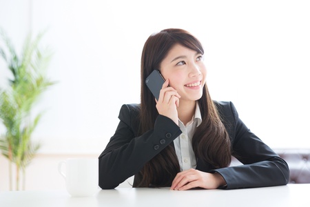 The Young businesswoman who talks on the telephoneの写真素材