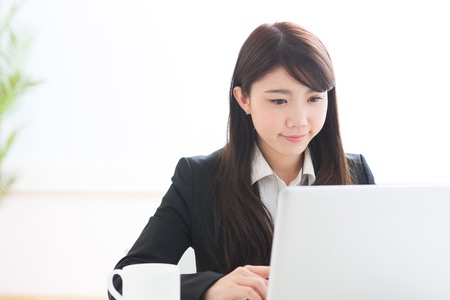 Young businesswoman who uses the computerの写真素材