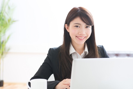 Young businesswoman who uses the computerの写真素材
