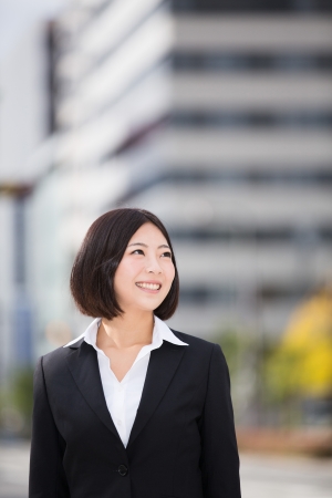 The Young businesswoman and buildingの写真素材